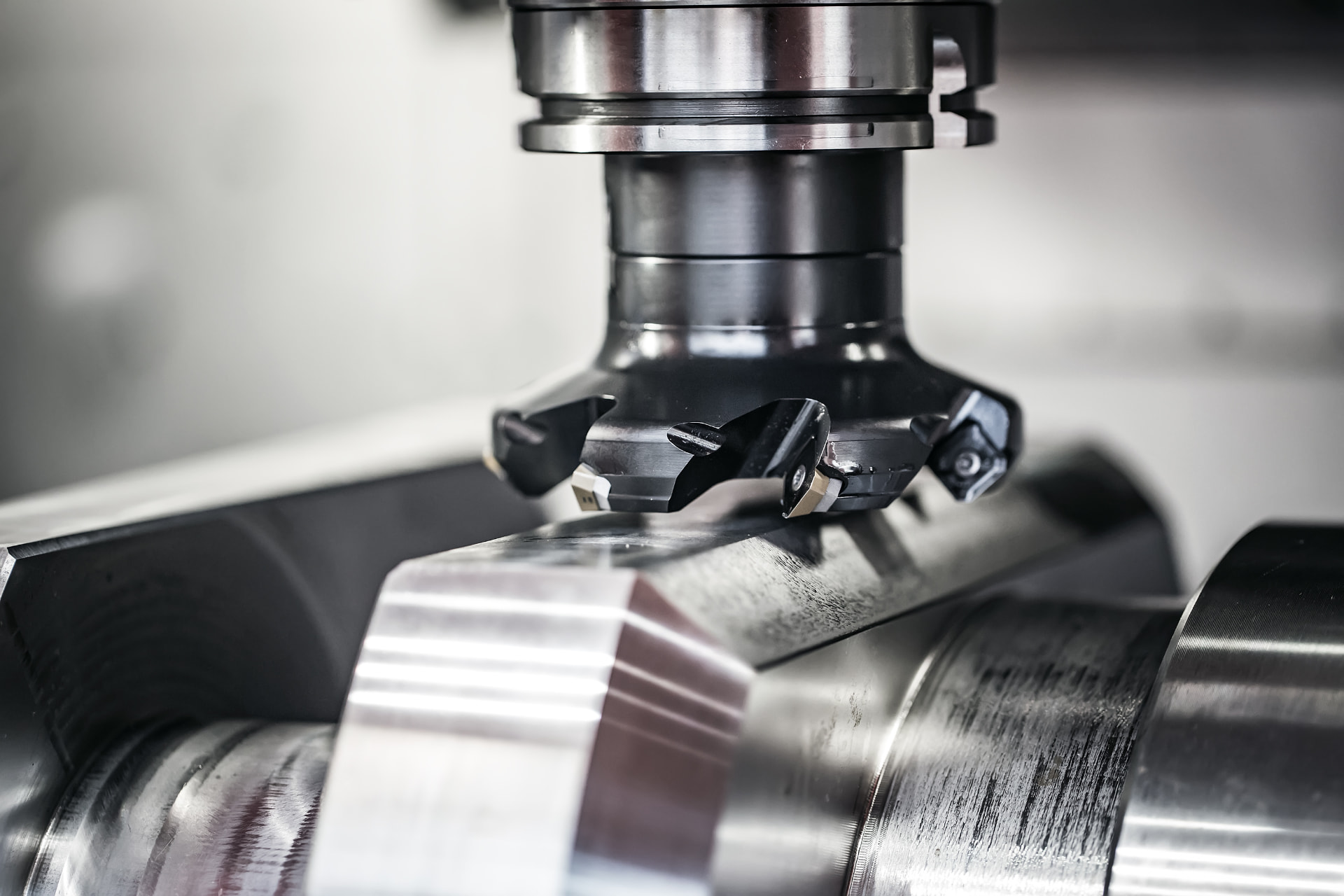 CNC milling cutter machining a steel shaft
