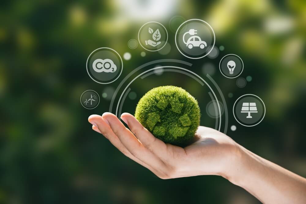 Hand holding a green globe surrounded by clean energy and CO2 icons