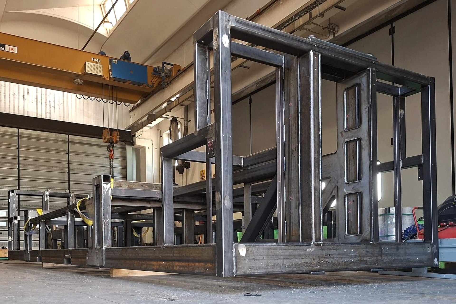 Large welded steel frame assembly under the workshop crane